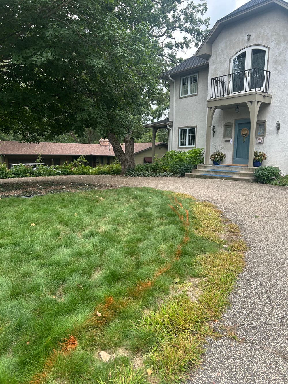 Beautiful suburban home with a landscaped lawn and inviting entrance.